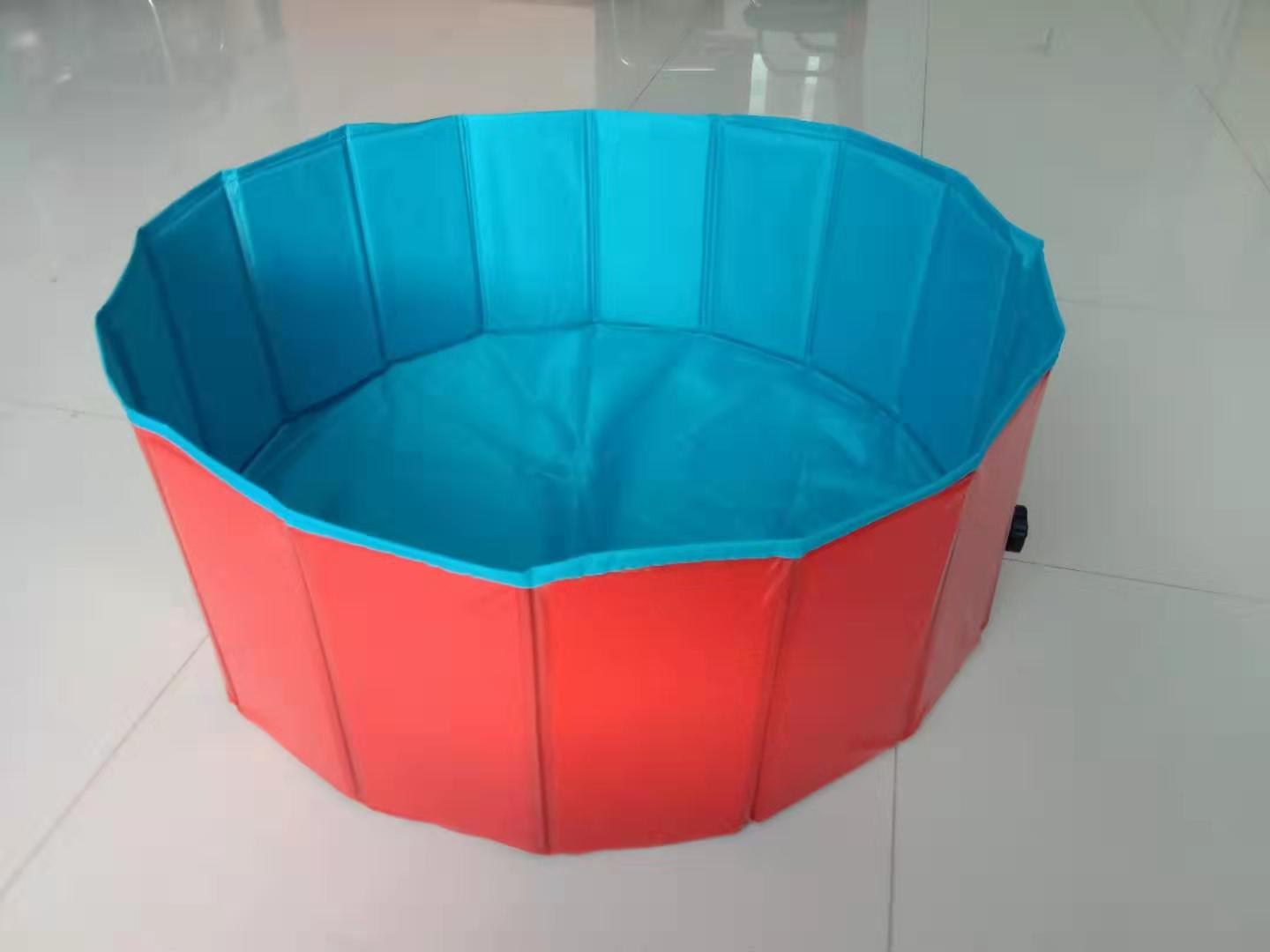Foldable Pet pool with blue top and red bottom on a white floor